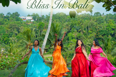 Stephanie Blake and girlfriends spinning in colorful gowns on the heart-shaped lawn at Swing Heaven Bali with the Ayung River valley in the background