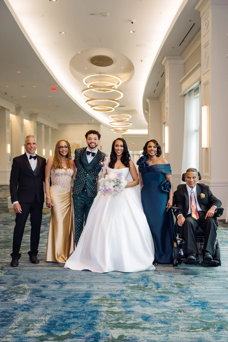 Jasmine and Maxwell celebrating with their family in a wedding portrait