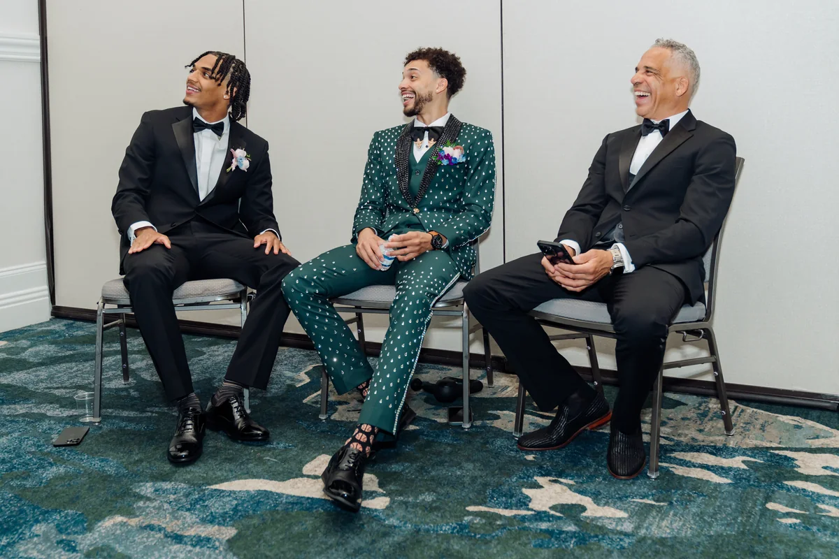 Maxwell with two family members dressed for the wedding