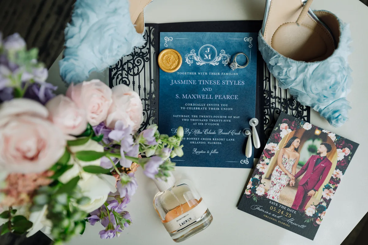 Jasmine and Maxwell’s wedding invitations beside the bridal bouquet