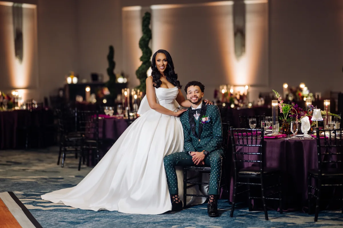 Jasmine and Maxwell posing together at their wedding reception