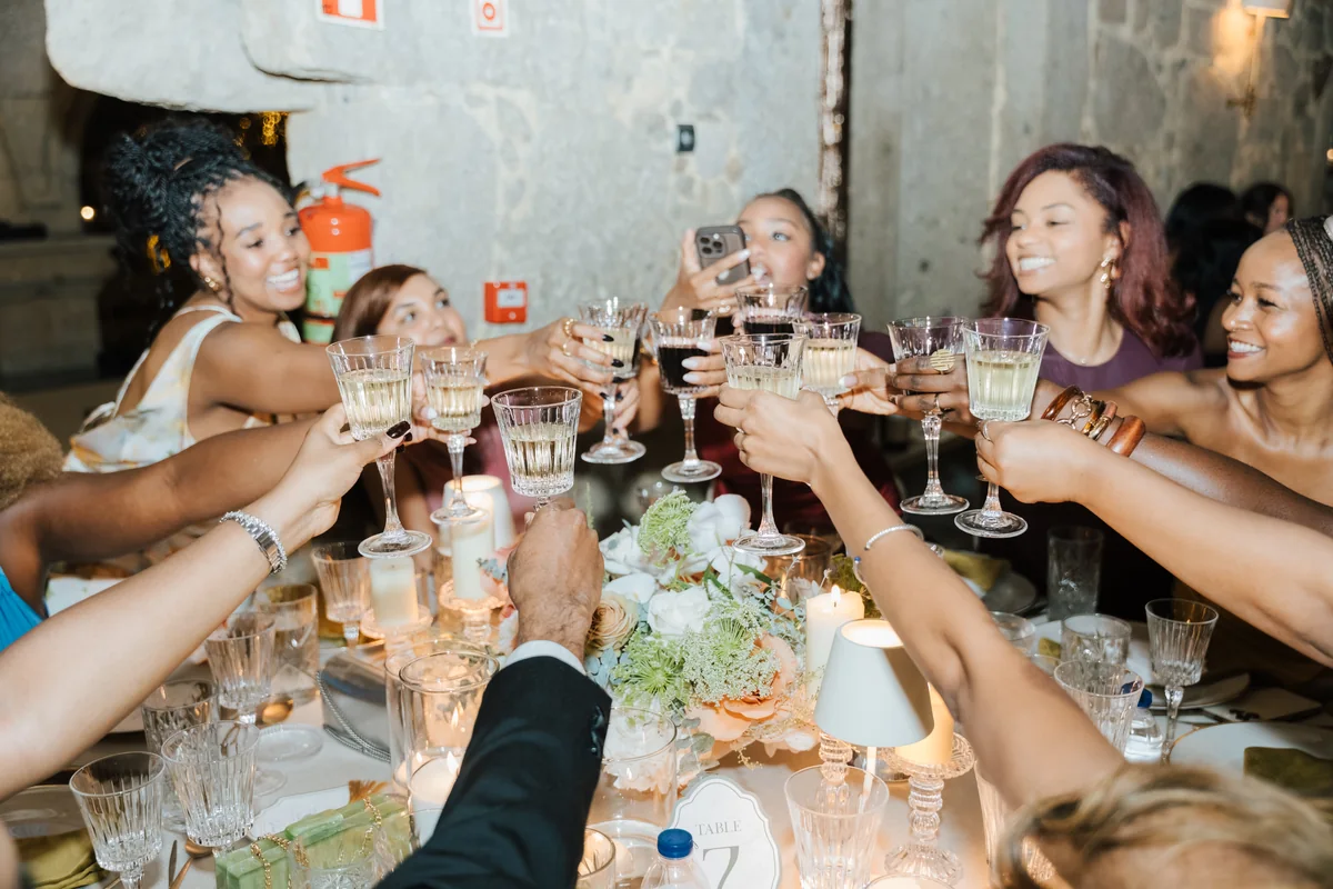 Jalin celebrating with guests during a wedding reception toast