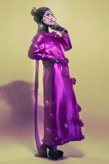 Samia Benchaou in a pink dress with a sculptural hat and gloves