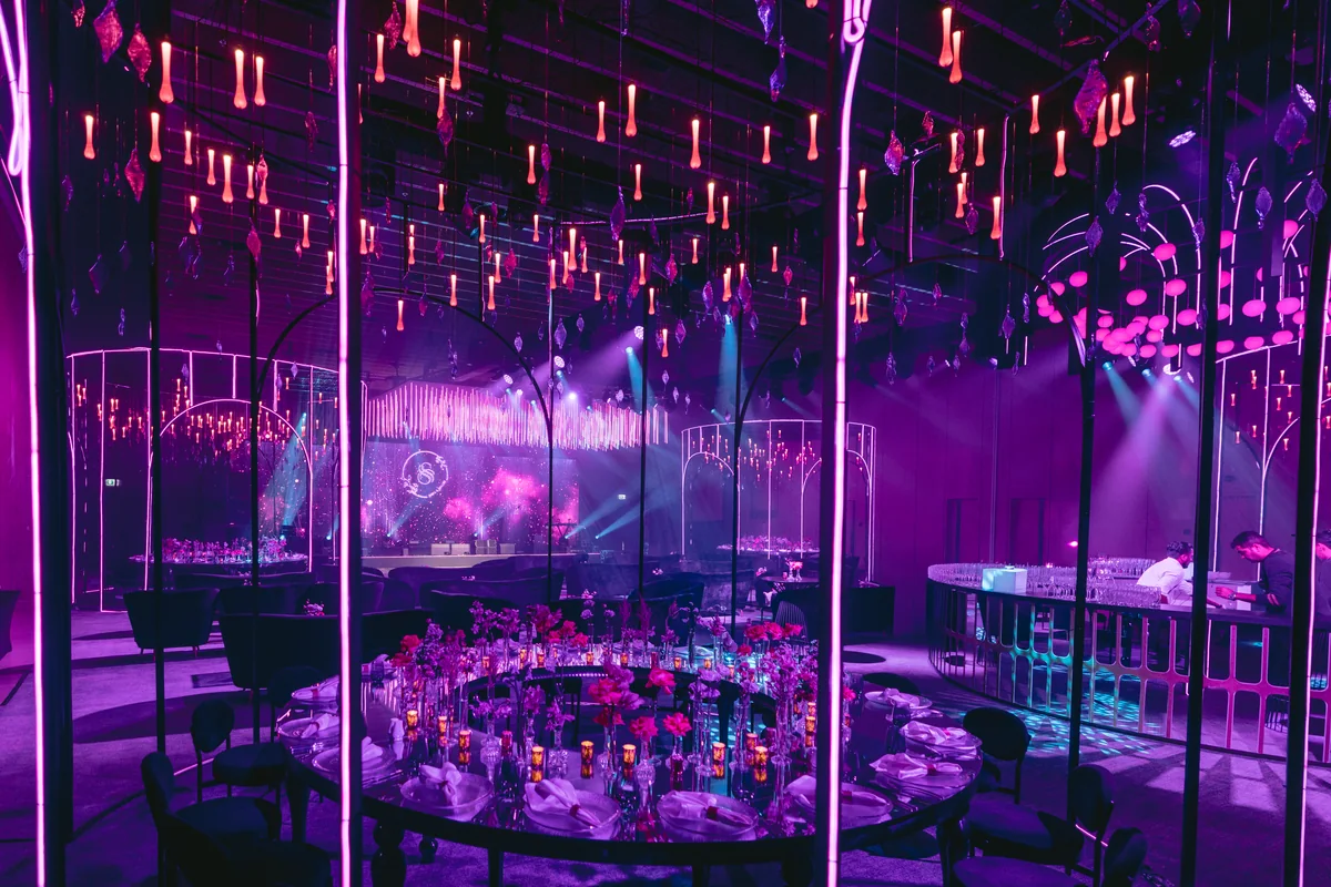 Purple lighting and floral arrangements at Shifa and Shahzeb’s reception
