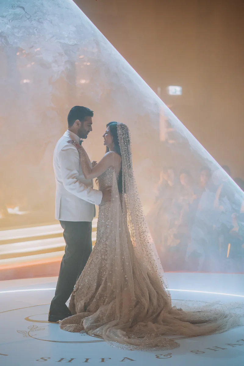 Shifa and Shahzeb posing together on an illuminated staircase