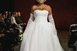 Model in a dramatic white ballgown with opera gloves and an embellished headpiece, Bi Pham Fall 2027