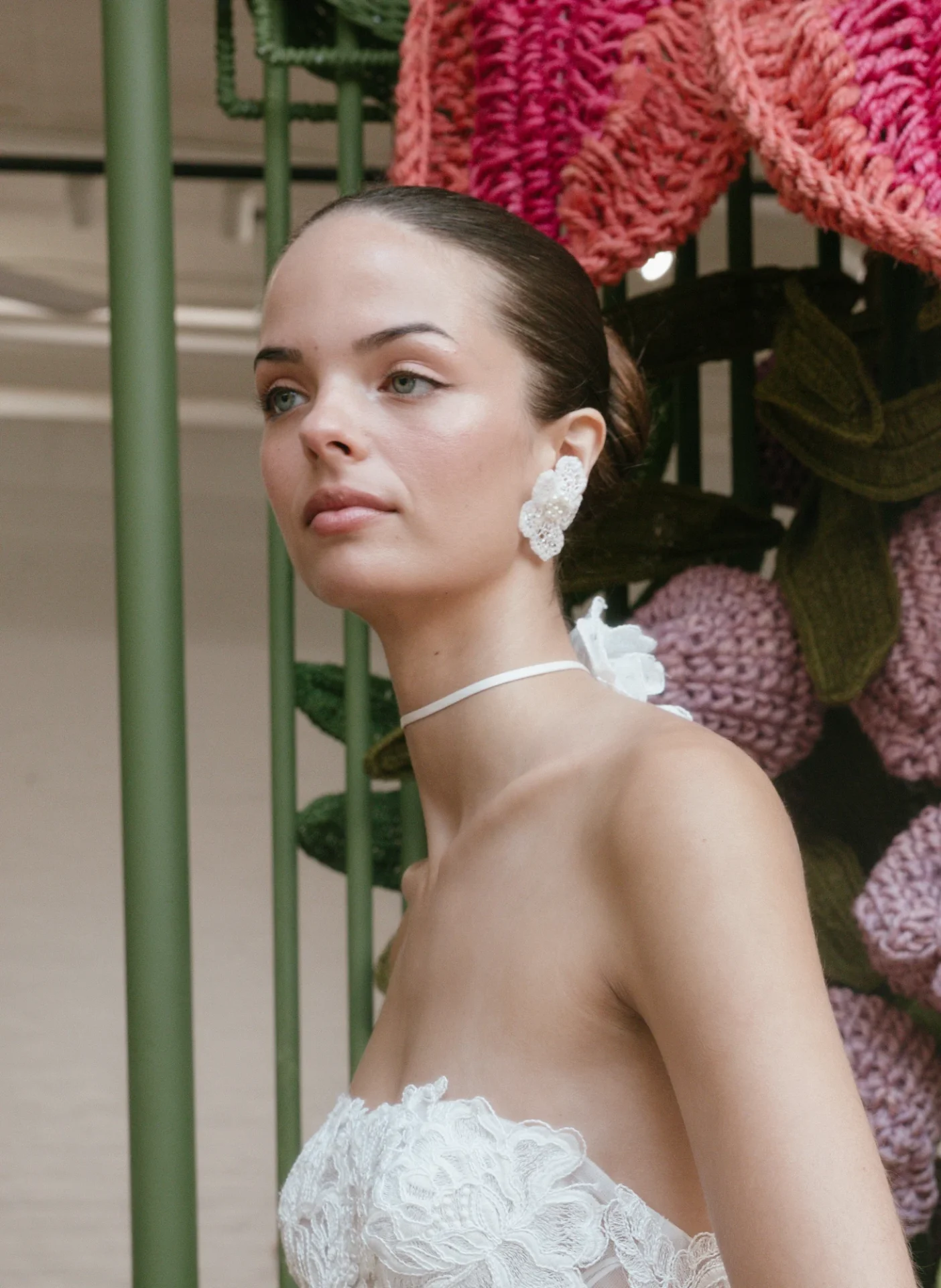 Close crop of a model with a medium complexion wearing the presentation’s soft bridal makeup