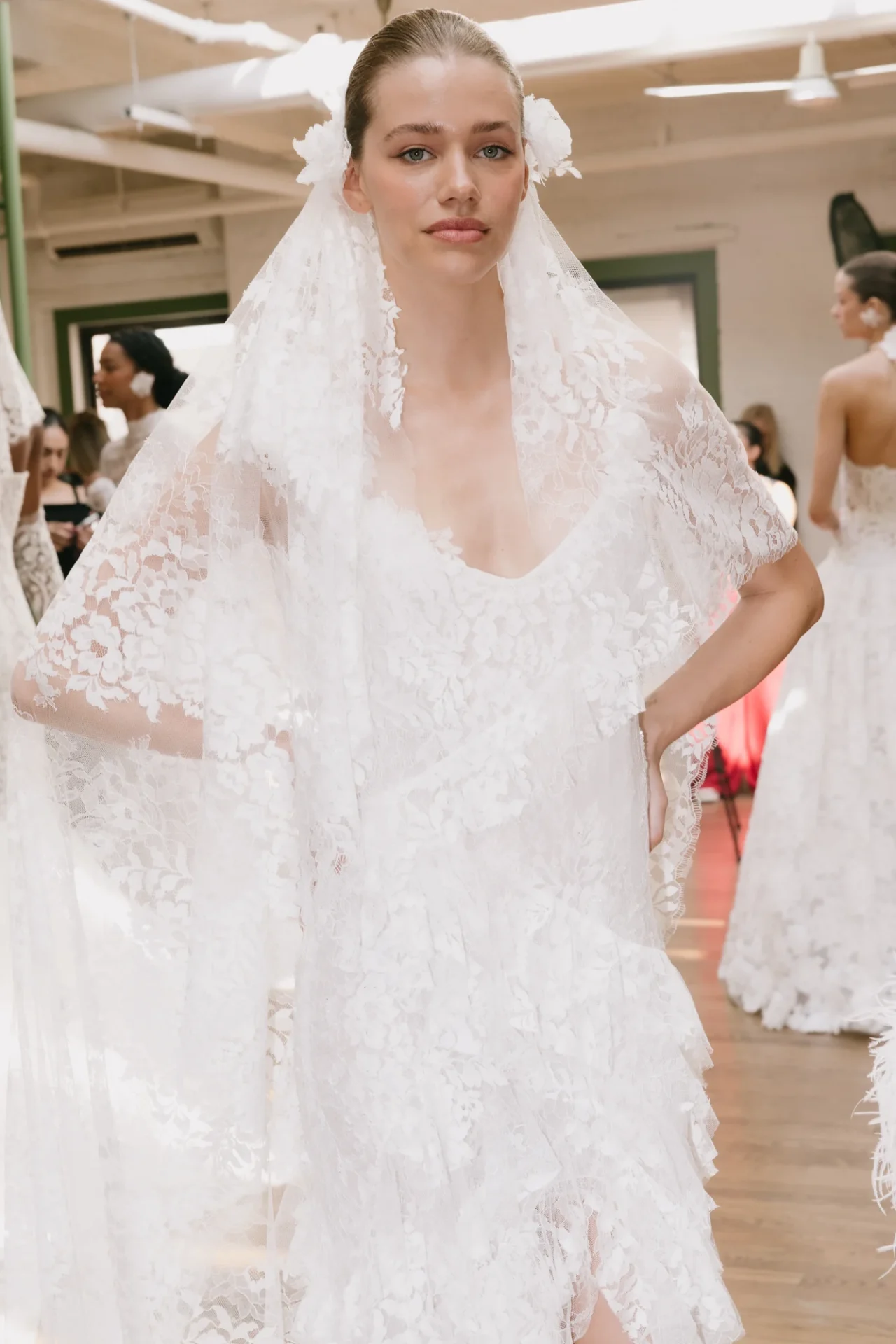 A model presents a dramatic lace cape gown during the Francesca Miranda Fall 2027 show