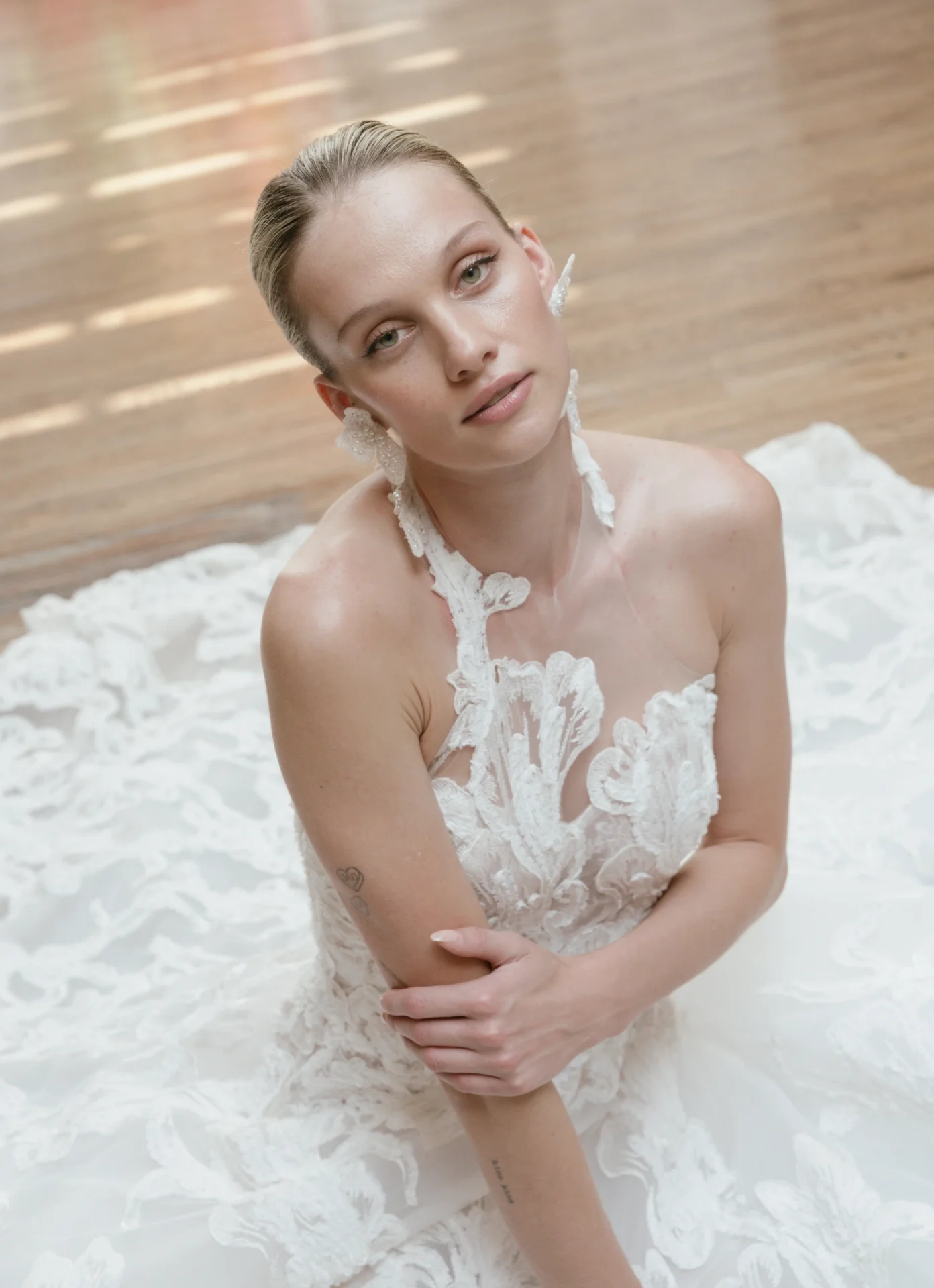 A full beauty portrait showing Francesca Miranda’s floral bridal earrings
