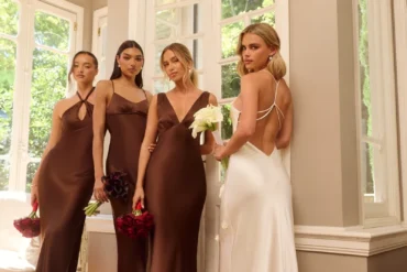 Hello Molly Wedding Parlour chocolate satin bridesmaid dresses beside a white bridal dress