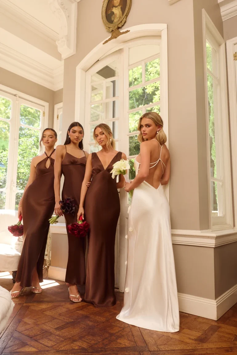 Hello Molly Wedding Parlour chocolate satin bridesmaid dresses beside a white bridal dress