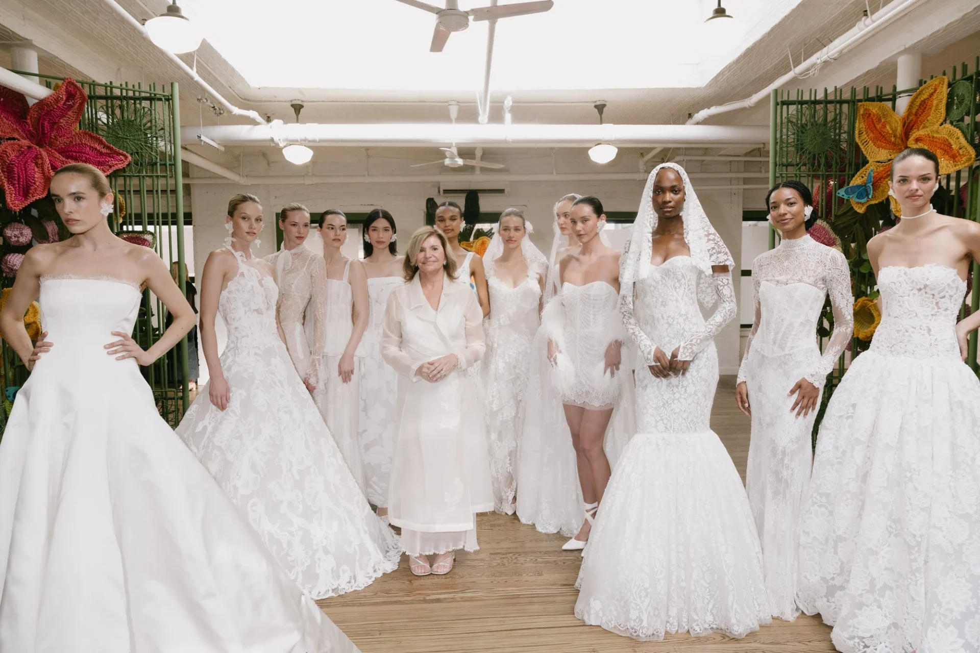 Models and guests gather among the colorful garden installation at Francesca Miranda’s Fall 2027 presentation